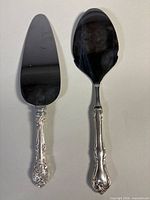 Two sterling-handled cake servers full view