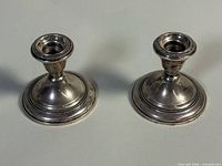 Both Wallace sterling weighted candleholders front view