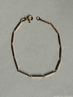 Full view of yellow gold bar-link bracelet with clasp