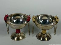 Front view of both olive bowls showing pedestal bases, bakelite spacers and attached cocktail picks