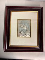Full view of framed plaque showing mat, frame, and silver relief