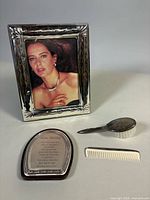 Group shot showing frame, blessing plaque, sterling brush and comb