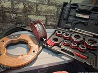 Overview of pipe threader kit, wire spool, fish tape reel and drain snake
