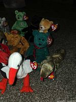 Group of Beanie Babies showing stork, lizard, bears, cat and tags