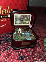 Kinkade wooden music box open showing interior diorama and Budweiser box in background