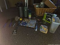 Full lot overview including thermoses, Presto EverSharp box, utensils, trivet, storage containers