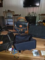Group view showing Dooney & Bourke satchel, Nine West tote, Liz Claiborne bag and smaller Nine West handbag