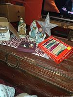 Three Wise Men, star topper, red box of glass ornaments, additional boxes visible