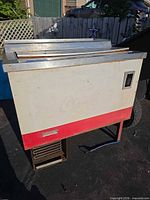 Full view of cooler showing body color scheme, louvered vent and stainless sliding lids