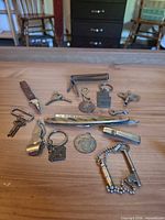Overview of all small metal keychain items laid out on table