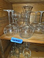 Full view of carafe and several balloon glasses on shelf