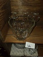 Princess House crystal ice bucket front view with six champagne coupe glasses arranged behind