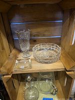 Vase, round ashtray and square ashtray together on shelf