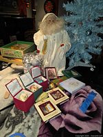 Overall lot showing Santa figure, blue tree, various boxed ornaments and sealed cylinder of silver balls
