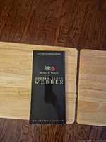 Front of black slipcase showing title and rose graphic