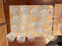 Overhead view of clear stemware showing quantity and varied pressed patterns