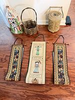 Entire lot showing three tapestries, birdhouse, basket, canister