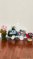 All four silk floral arrangements lined up on floor