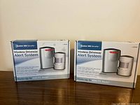 Front view of two boxed alert systems