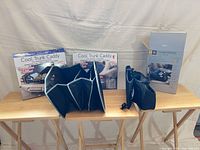 Two Cool Trunk Caddy boxes, unfolded trunk organizer, boxed Case Logic organizer and loose Case Logic organizer