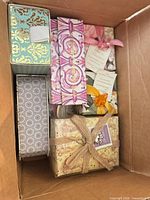 Box with assorted decorative soap boxes and wrapped bars