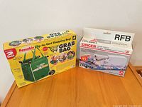 Both retail boxed items side by side on table