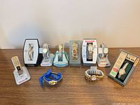 Group shot of all 10 wristwatches on stands and packaging