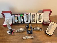 Entire lot showing all boxed and loose watches on table