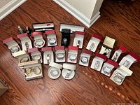 Wide shot of all boxed watches and bracelets on hardwood floor