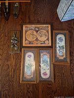 Group view showing map print, two botanical prints, and wood plaque