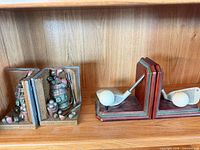 Two pairs of bookends: golf club/ball pair and open-book golf bag pair