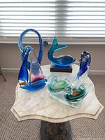 Group shot of all five glass sculptures on table