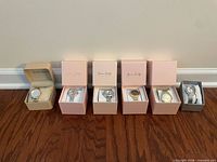 Group of six boxed wristwatches on floor