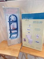 Both boxed products: Mainstays Bath in a Box set and Malla Faux Marble Shower Caddy