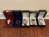 Group shot of five boxed wristwatches on floor