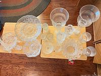 Overhead view of entire mixed clear glass/crystal lot on wooden boards