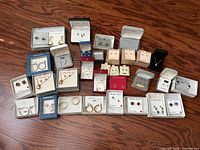 Overall lot view of boxed and carded jewelry pieces
