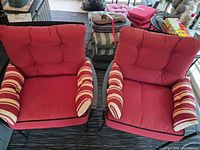Pair of lounge chairs side by side showing frames, cushions, striped pillows