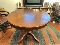 Table in round configuration showing top and pedestal base