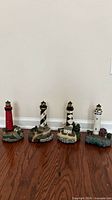 Group shot of all four lighthouse figurines