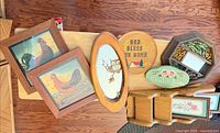 Grouped view of six wall décor pieces on tabletop
