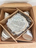 Boxed set showing four teacups and stack of saucers