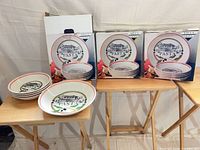 Three boxed Villa Oliva pasta bowls alongside stacked bowls on tables