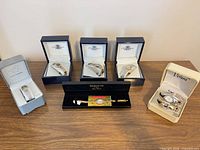 Group shot of all six boxed wristwatches