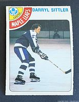 Front of the Darryl Sittler 1978-79 O-Pee-Chee card showing action photo and Maple Leafs banner