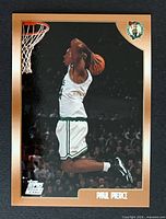 Front of Paul Pierce 1998-99 Topps rookie card showing action image and gold border