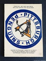 Front of sticker card showing Pittsburgh Penguins logo and bilingual instructions