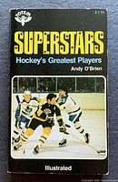 Front cover showing title, author, publisher logo and hockey action image