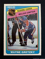 Front of Wayne Gretzky 1984-85 OPC card showing action image and bilingual scoring leader banner