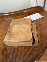Closed book showing worn leather cover and wrap flap